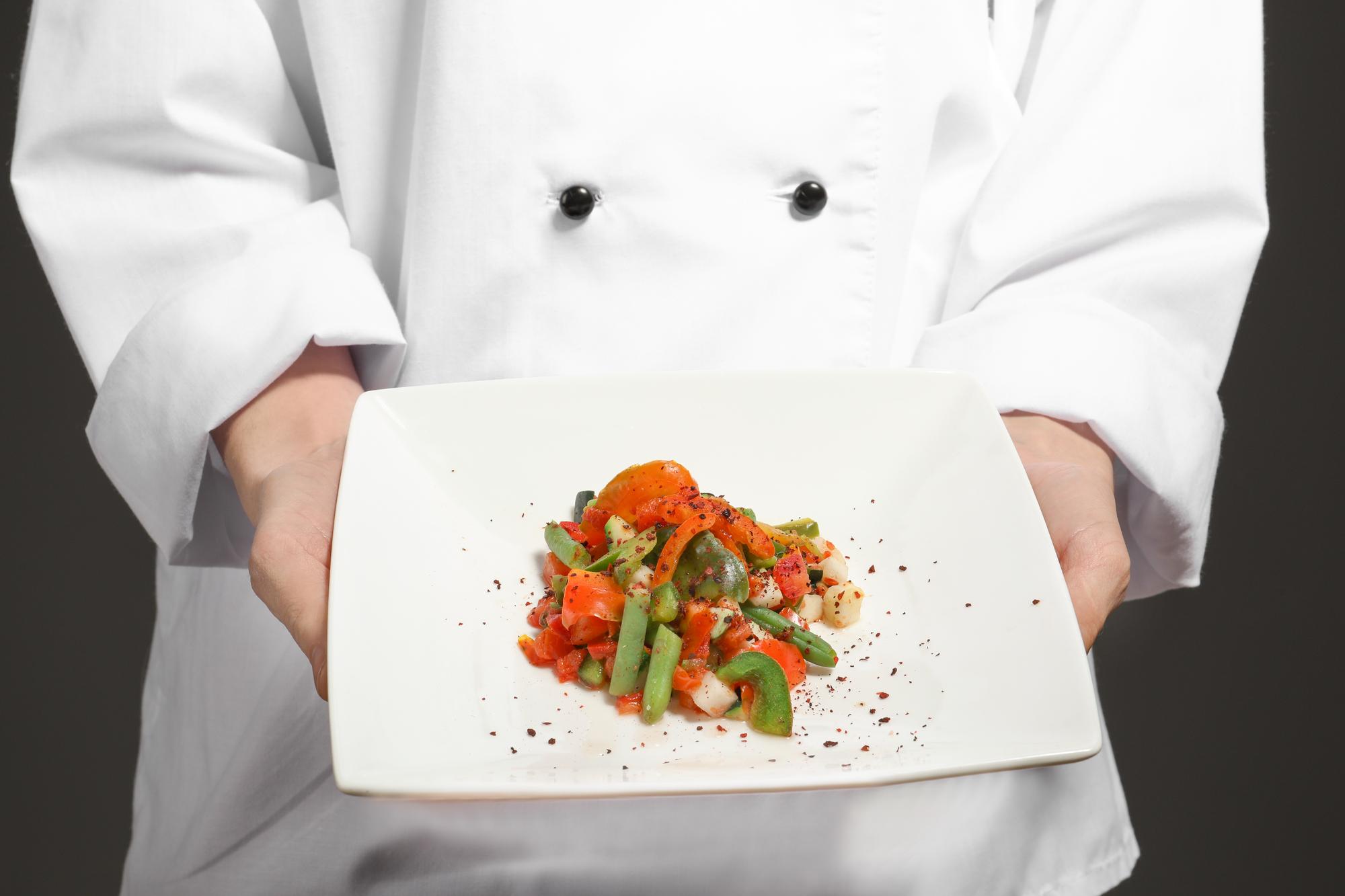 Chef using modern kitchen tech to plate dish